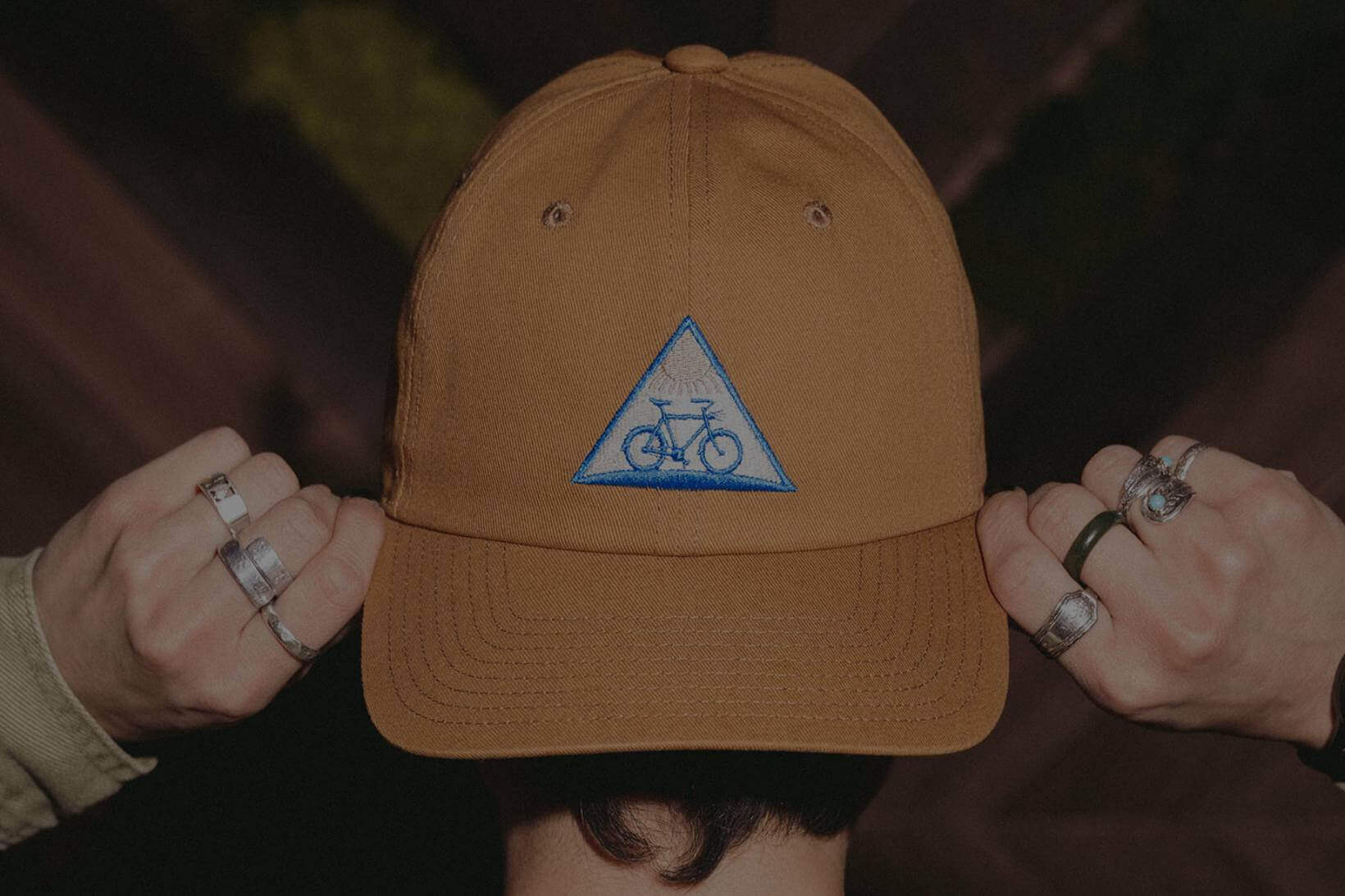 Back of person's head wearing Fat Tire hat backwards